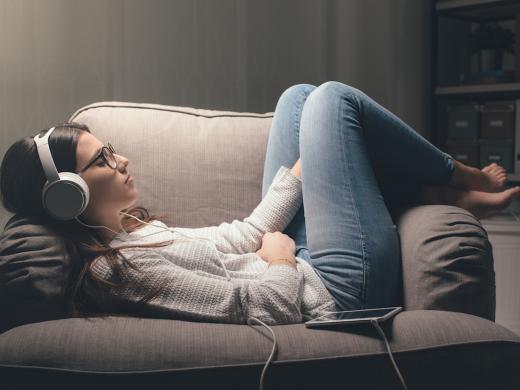 Vrouw luistert muziek op stoel